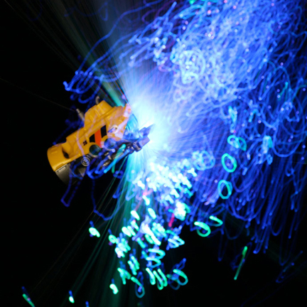 Toy submarine exploring a fiber optic light show in the deep abyss